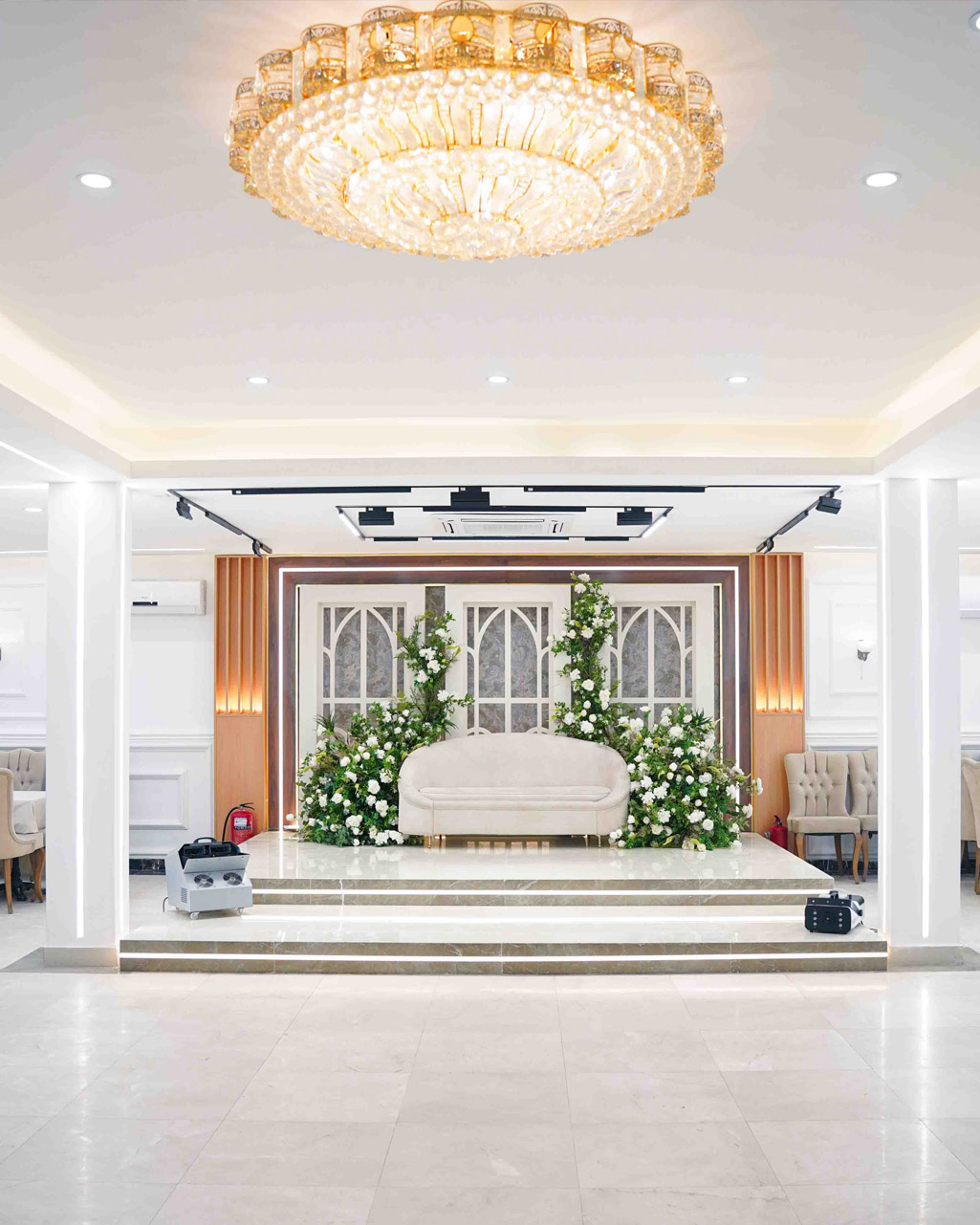 A beautifully decorated grand room, set up for a luxurious event.