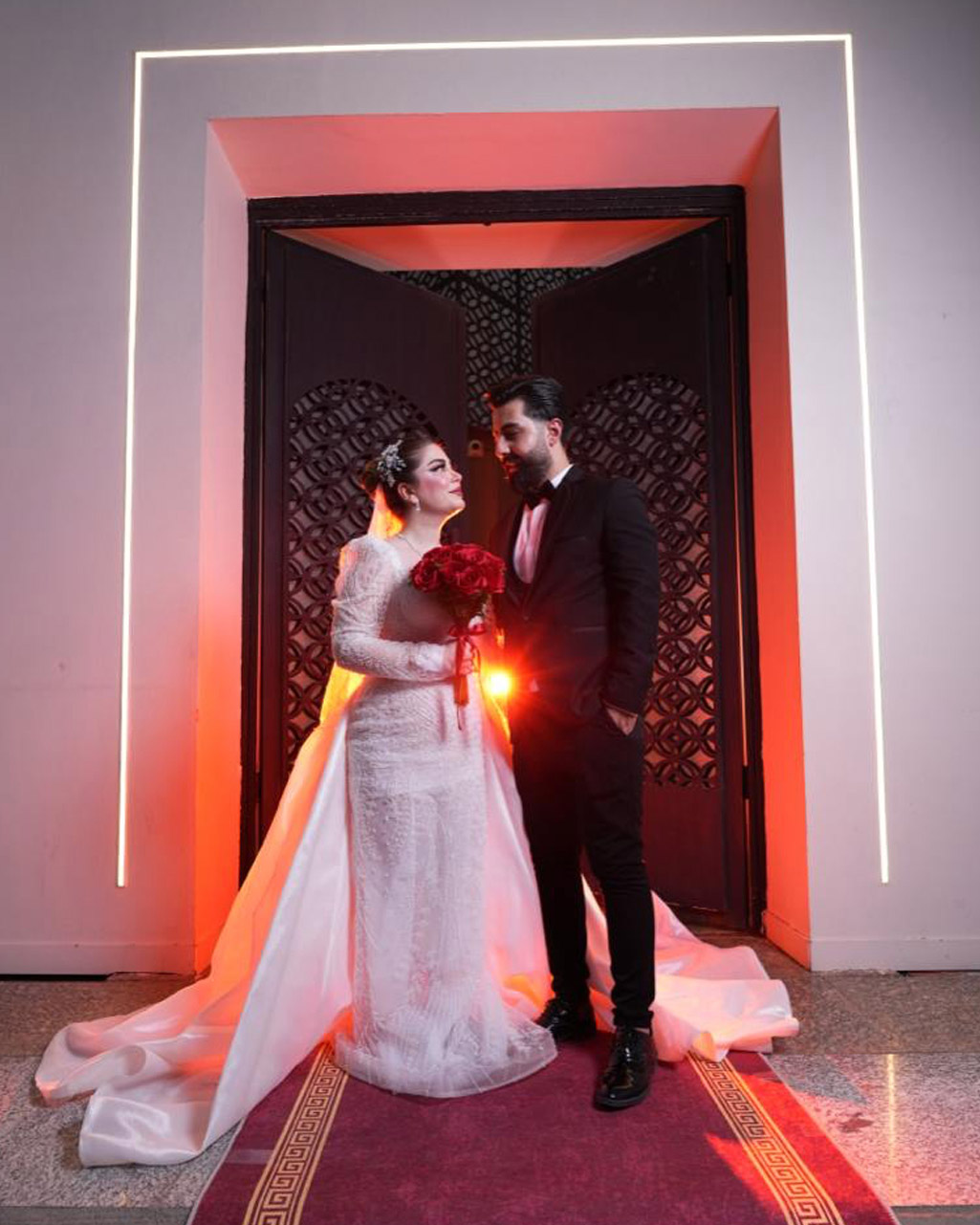 An elegant wedding reception with floral arrangements and stylish chairs.